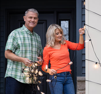Pete and Megan from PowerHouse with holiday lights