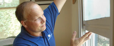 Home inspector checking a window