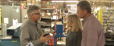 Man showing ductwork to Pete and Megan