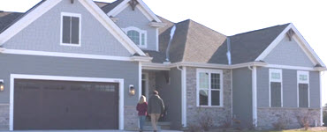 Two people walking into a new home