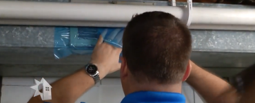 Man working on furnace ductwork