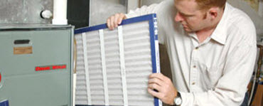 Man inserting an air filter