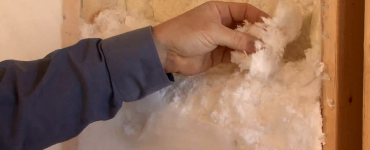 Man touching spray foam insulation