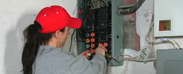 Electrician working on a circuit breaker