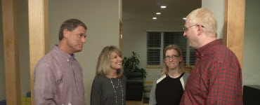 Pete and Megan talking with homeowners