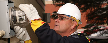 Utility worker with an electric meter
