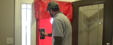 Energy rater performing analysis on a front door