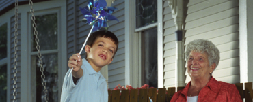 Boy and grandmother on front porch