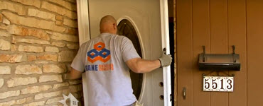 Worker installing a new front door