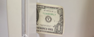 dollar bill in refrigerator door