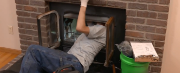 Inspector looking inside fireplace