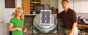 Megan and Pete standing next to solar attic fan