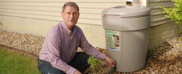 Pete next to a rainwater barrel