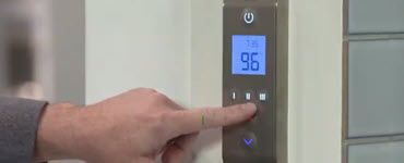 Finger pressing a shower technology panel