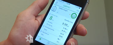 Person holding cell phone with energy management app